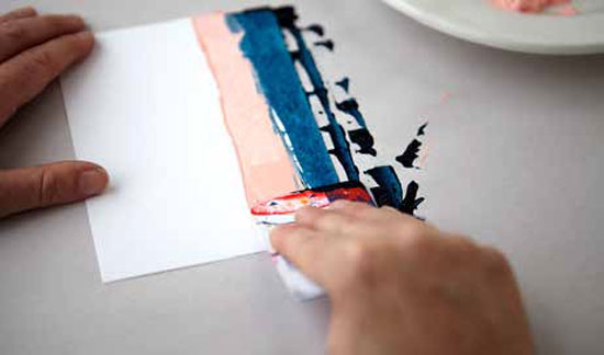 Load the credit card with paint, gently press and drag it down across the notecard.